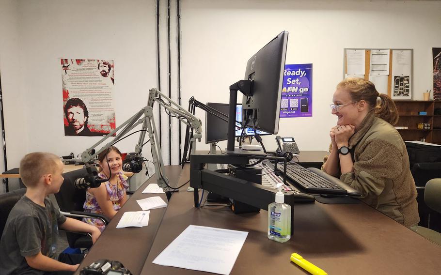 Military-connected kids Zoey and Joey visit with AFN radio host SrA Brooke A. Sorensen during Month of the Military Child.