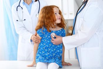 Doctor examining a little girl with stethoscope