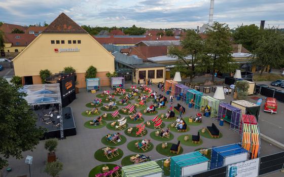 Picture of people enjoying an outdoor concert in lawnchairs 
