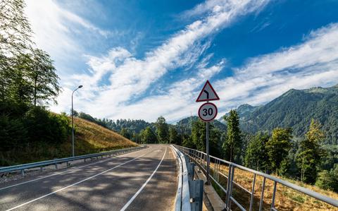 Photo Of Beautiful mountain road. Early morning sunlight and blue sky.