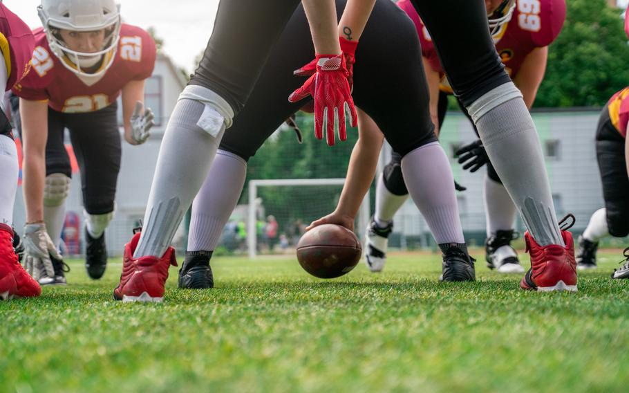 American football players with ball on the playing field