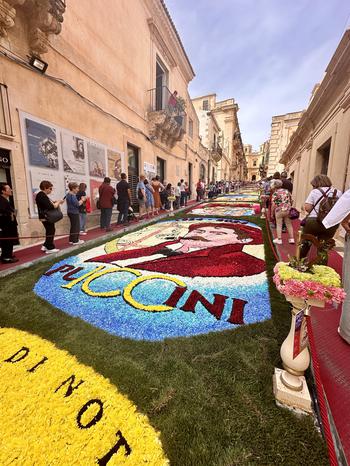 People standing on both sides of painted grass art