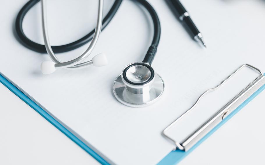 Stethoscope for medical health care on clipboard with paper
