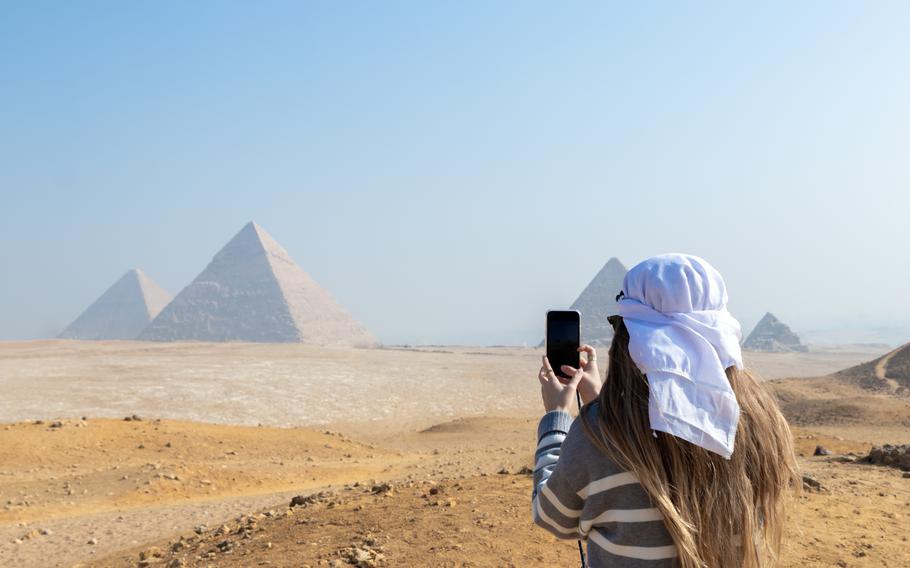 Teen taking photos of the pyramids at Giza