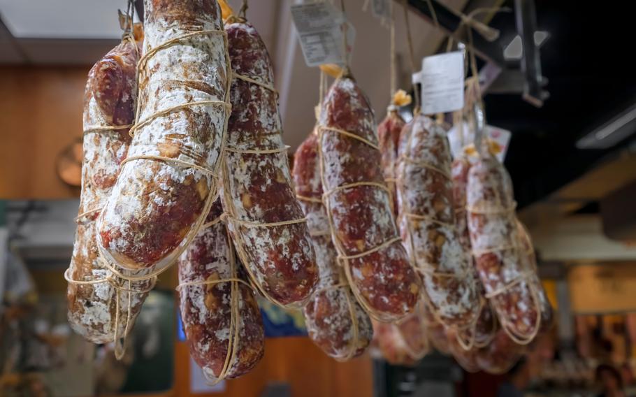 Salami sausage on display for sale hanging at a salumeria meat and cheese shop 