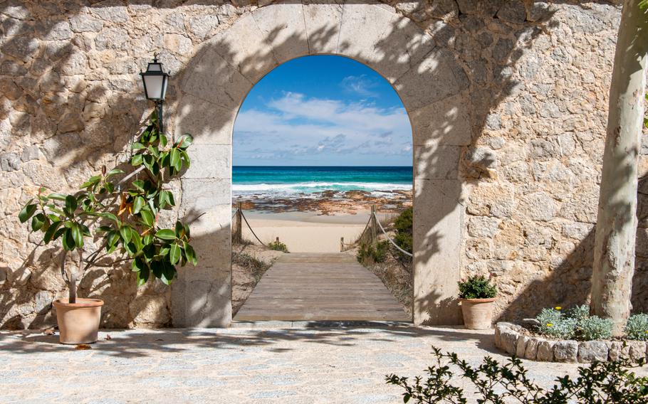 a stone archway leading to the beach