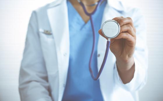 Doctor woman holds stethoscope head, close-up. Physician ready to examine and help patient. Helping and insurance in health care, best treatment and medicine concept.