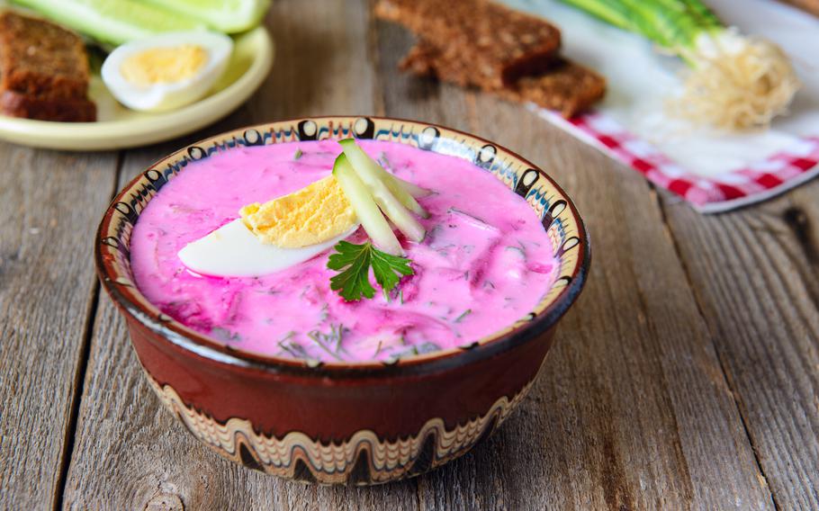 a bright pink soup with hard boiled eggs on top
