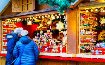 Man and woman looking at decorations hanging at a stall