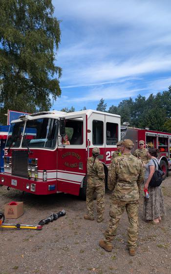 Service members and families checking out the fire truck