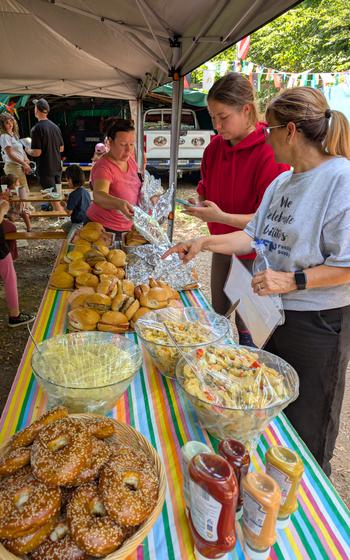People grabbing food from the table