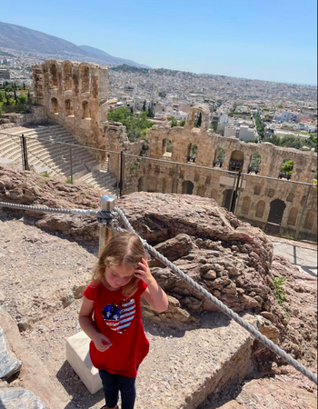 Little girl standing in front of architecture