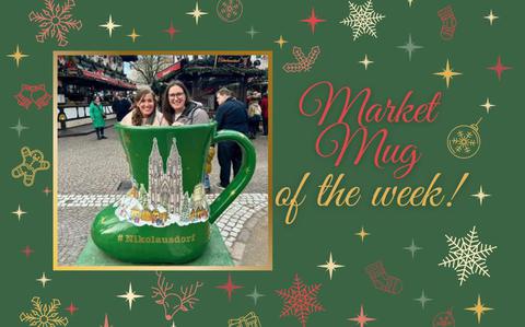 Photo Of A giant, bright green, boot-shaped Christmas market mug with two smiling women inside.