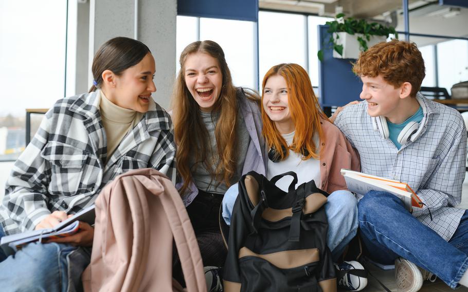 Group of young adult students in classroom.