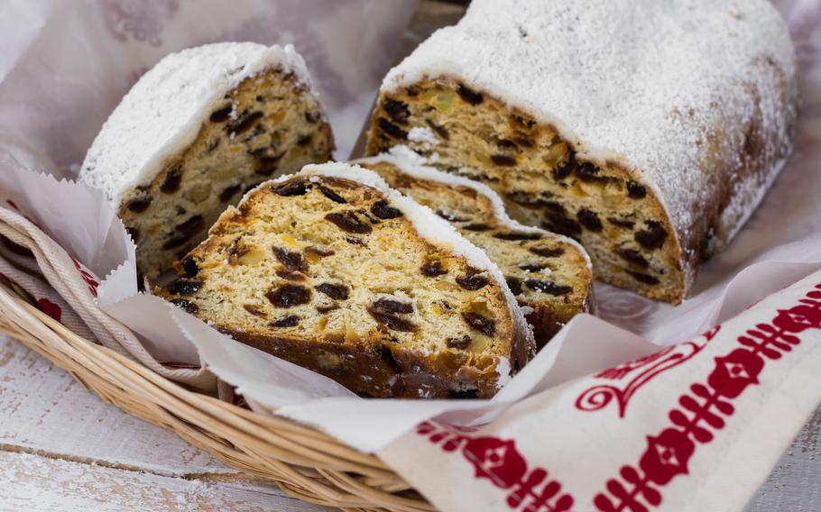 A close-up picture of stolen bread with raisons inside. The top has a blanket of powdered sugar on it. 