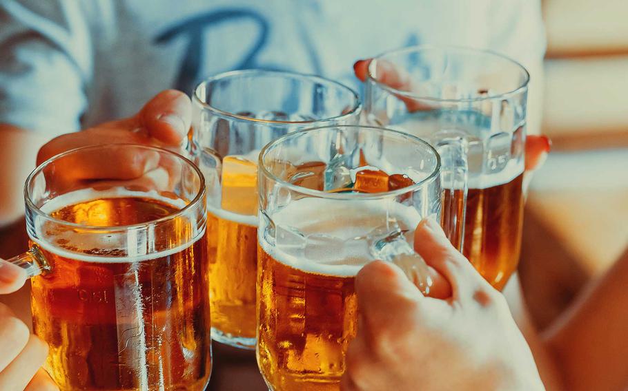 Beer glasses clinging together.