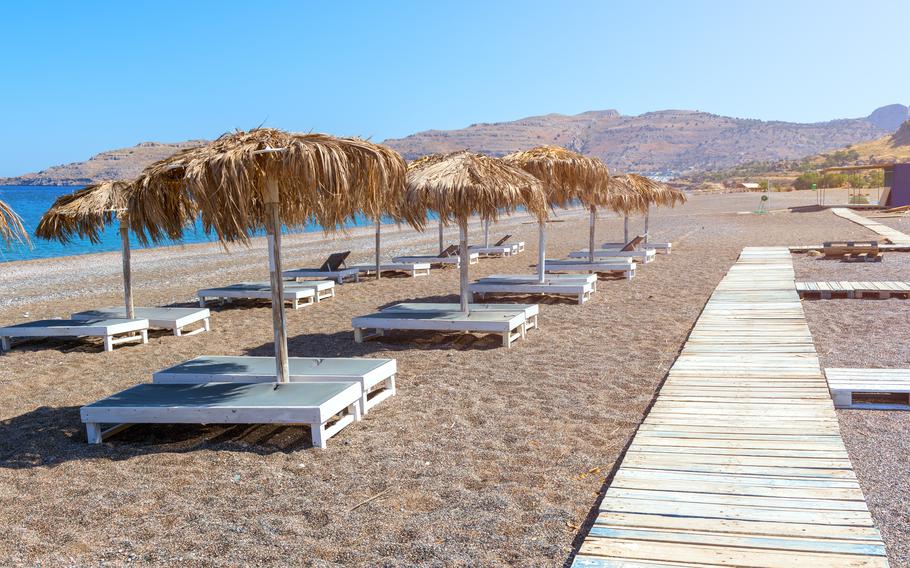 Sun loungers on a beach in Rhodes, Greece.