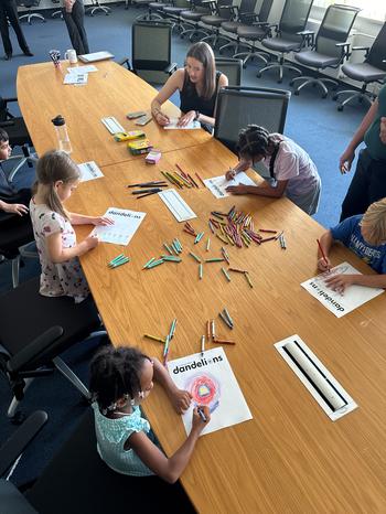 Students and Stripes’ worker coloring at the table