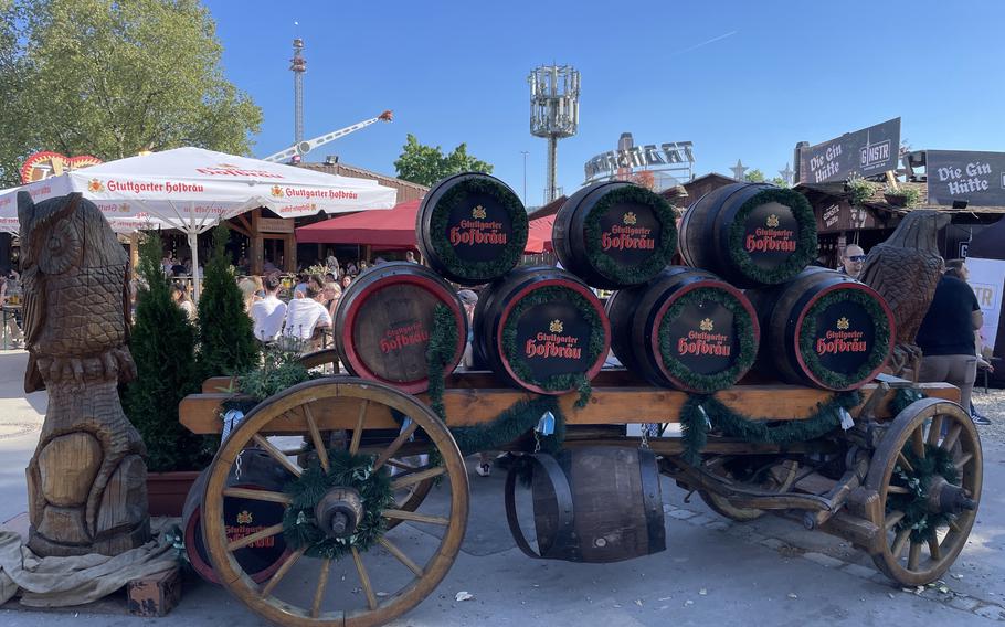 Black barrels with red writing on top of a large wooden cart