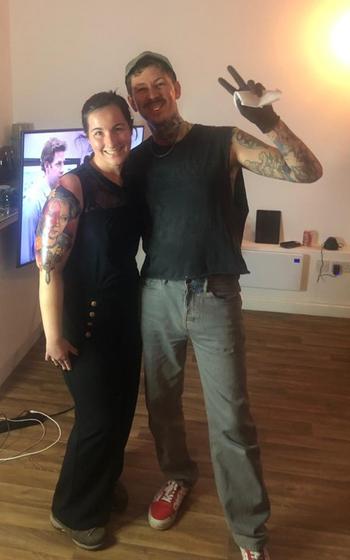 Writer standing next to tattoo artist, Freddie Albrighton in his tattoo studio