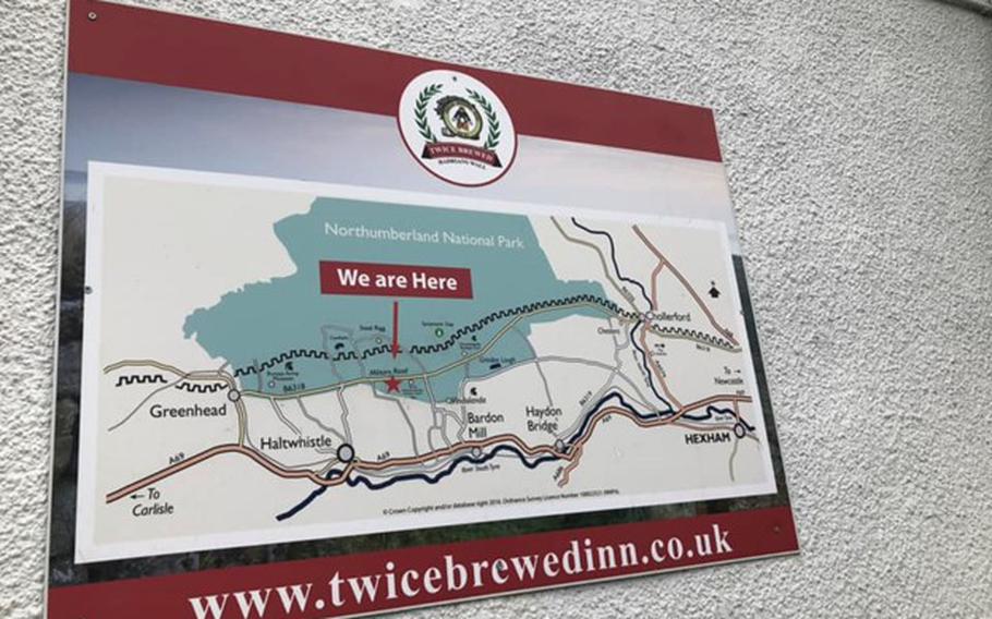 Sign featuring a small area map with a red star noting where patrons can find Twice Brewed Inn which reads “you are here.”