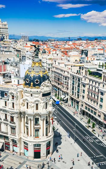 Skyline of Madrid with Edificio Metropolis and Gran Via, summer sunny day, cloudscape sky.