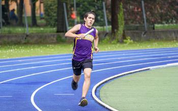 James S. running on track with baton in hand