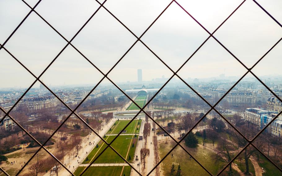 a  platform in the foreground, up high over a cloudy view showing Paris. 