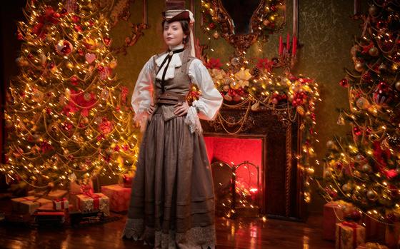 Photo Of steampunk lady stands in a vintage room fabulously and ornately decorated for Christmas