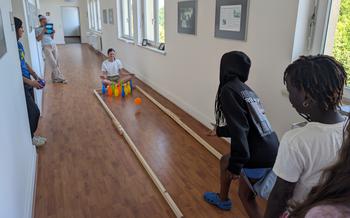 Kids bowling in the hallway