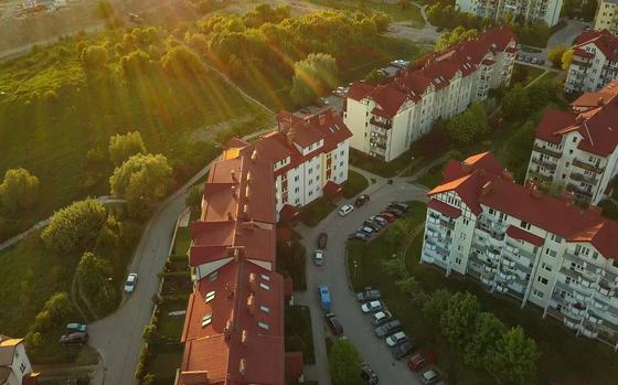 Aerial of residential area at sunset with blocks of flats and houses