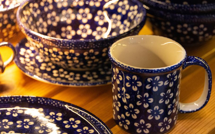 a mug and bowl with a white flower pattern 