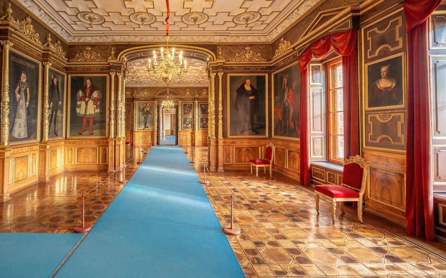 Step inside the majestic Schwerin Castle and explore its grand interiors, adorned with historic portraits, intricate woodwork, and elegant chandeliers. A must-visit for history and architecture lovers.