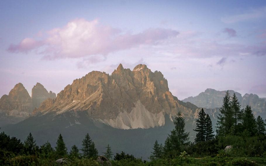 Brown mountain against a blue and purple sky at Lago di Sorapis