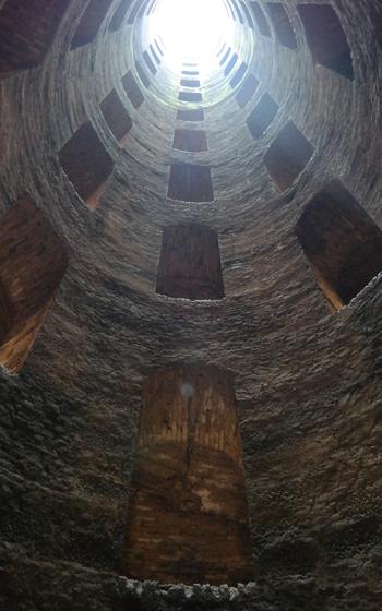 Interior of St. Patrick’s Well with the sun beiming in from the hole above