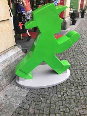 Green Ampelmann on sidewalk in front of store