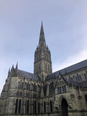 Exterior of Salisbury Cathedral; white cloud behind Cathdral tower