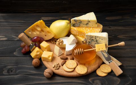 Photo Of Cheese collection. Camembert, brie, gorgonzola and other cheeses on wooden background