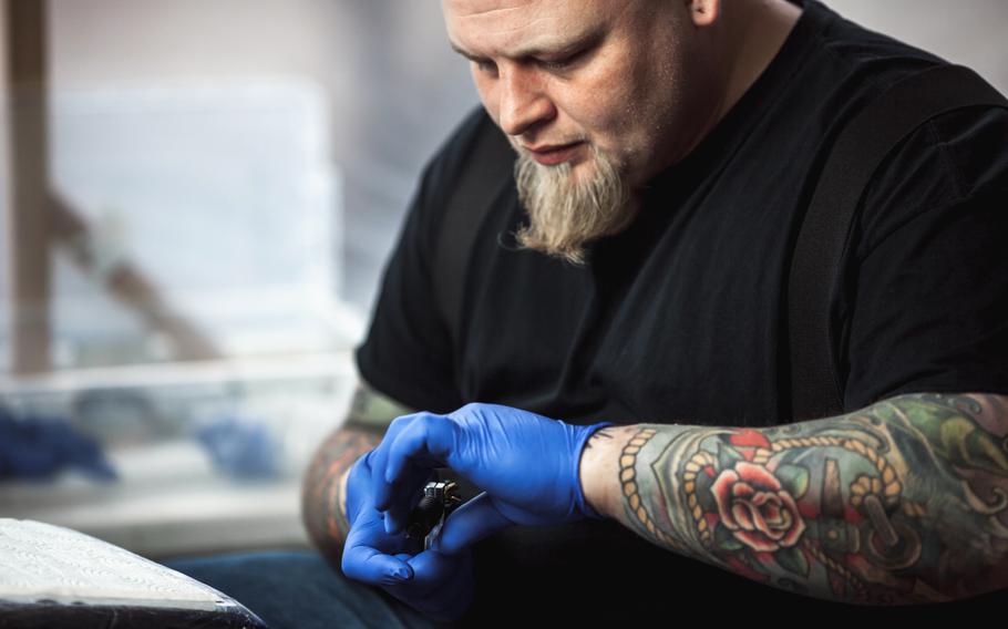Tattoo artists preparing tools