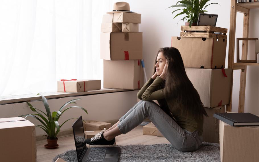 Woman frustrated by moving boxes