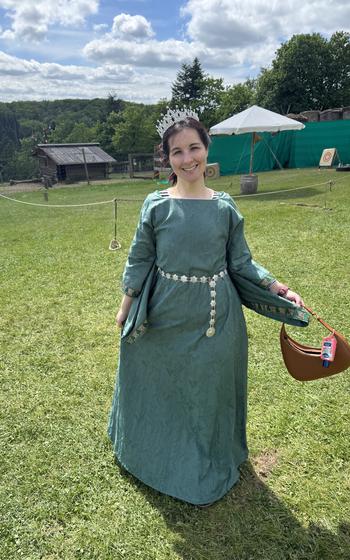 Writer in teal color medieval-style dress