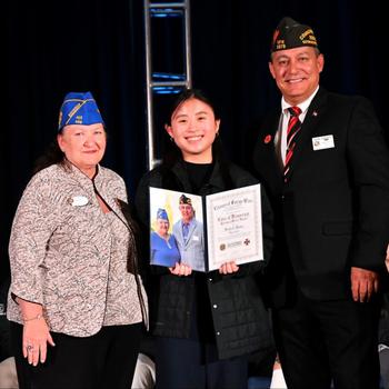 ARLINGTON, Va. (March 4, 2024) VFW Auxiliary President Carla Martinez (left), Voice of Democracy VFW Department of Europe winner Meredith Maxwell (center), and VFW National Commander Duane Sarmiento (right) at the 2024 Voice of Democracy Parade of Winners ceremony. Maxwell, from Ansbach, Germany, was awarded the $2,000 Department of Connecticut and Auxiliary Scholarship.