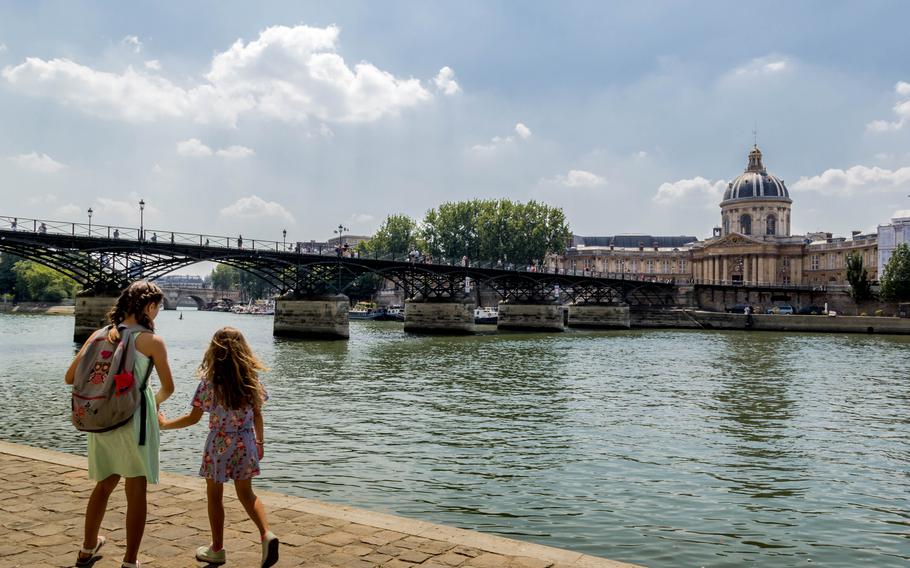 The Pont des Arts bridge is known as the love-lock bridge and crosses the Seine River.