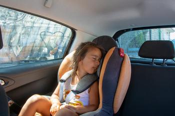 Little girl asleep in car seat