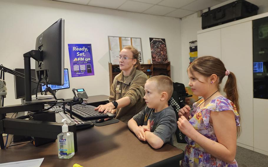Military-connected kids Zoey and Joey visit with AFN radio host SrA Brooke A. Sorensen during Month of the Military Child.