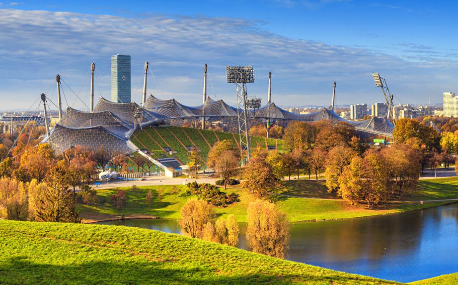 An autumn view of the stadium overlooking the lake and bright orange trees.