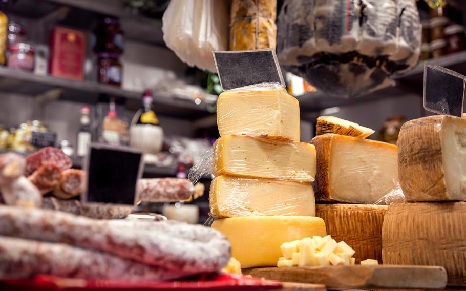 Italian food market with cheese and pepperoni, formaggio crociato fresco, Tuscan delicatessen stall display, Florence, Italy 