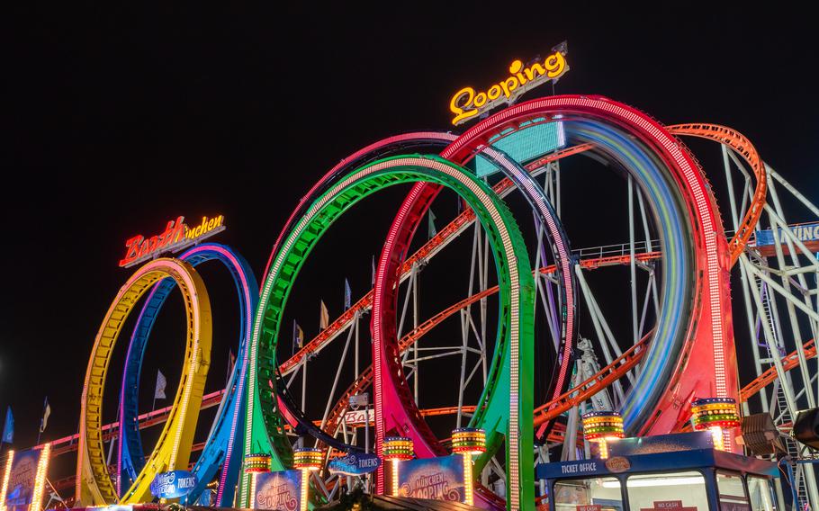 A colorful 5-loop rollercoaster that looks like the olympic rings in neon yellow, blue, green, red, and orange