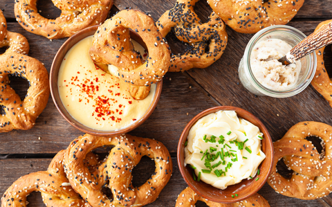 Photo Of Differently topped pretzels with dips