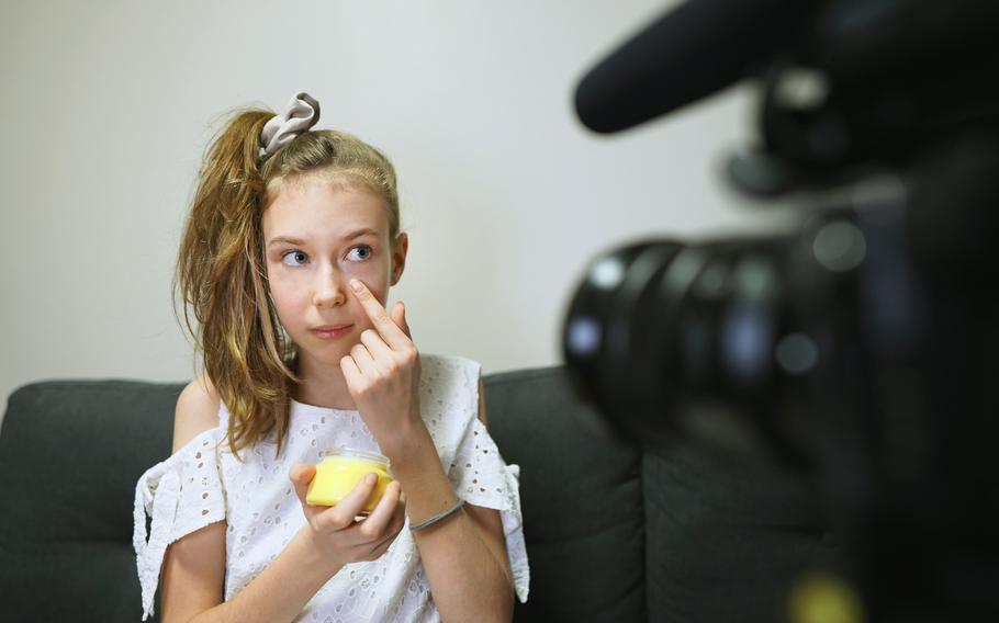 Teenage girl making video blog about skincare. 
